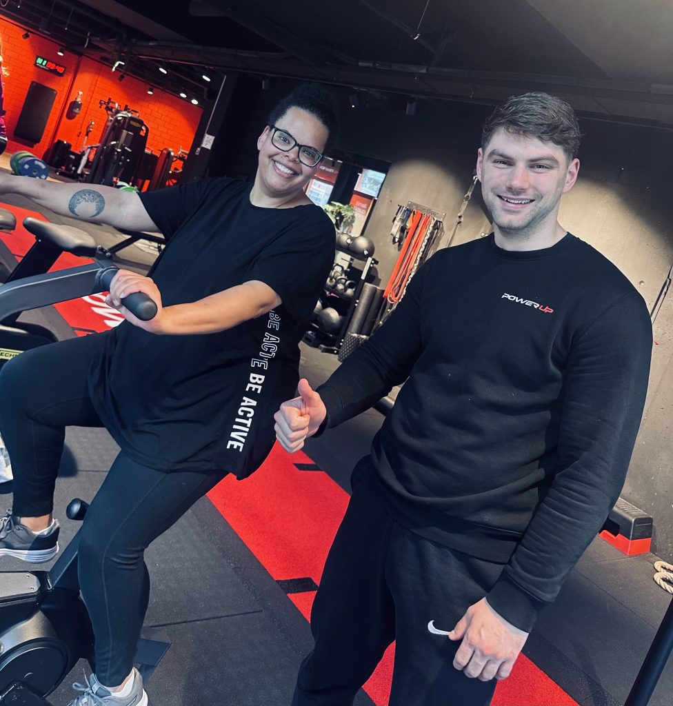 personal trainer and trainee smiling while training.
